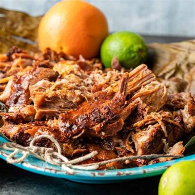  Cochinita Pibil:  A Symphony of Slow-Roasted Pork and Tangy Citrus Marinades!